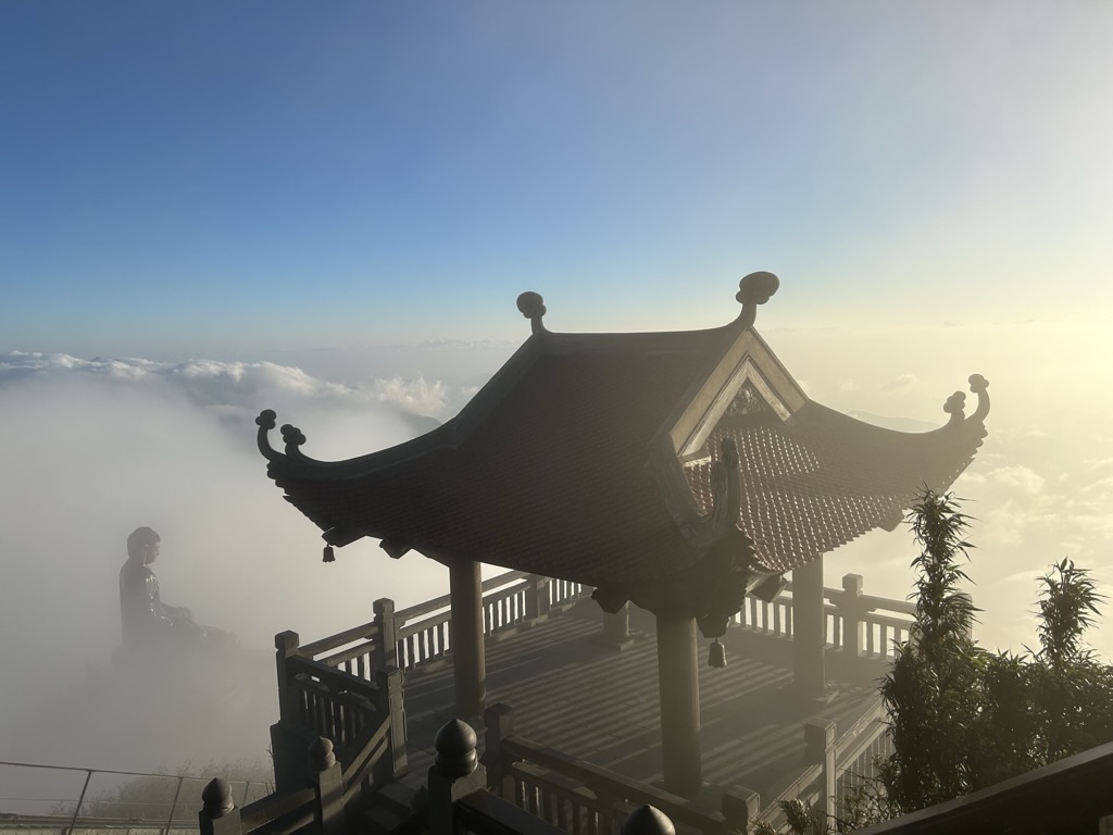 Temple on Fansipan rising above the clouds at sunrise